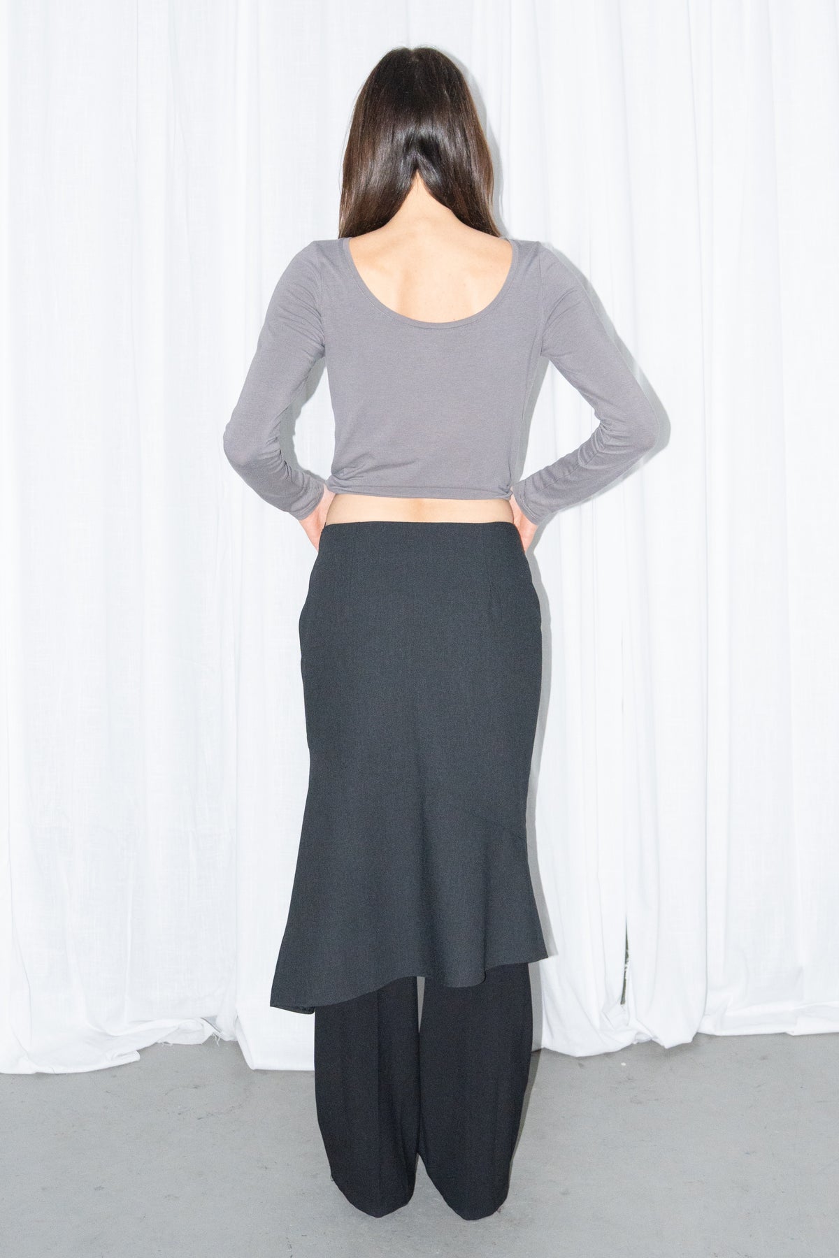 Model wearing grey fitted long-sleeve top with a black flared midi skirt – MINIFALDA
