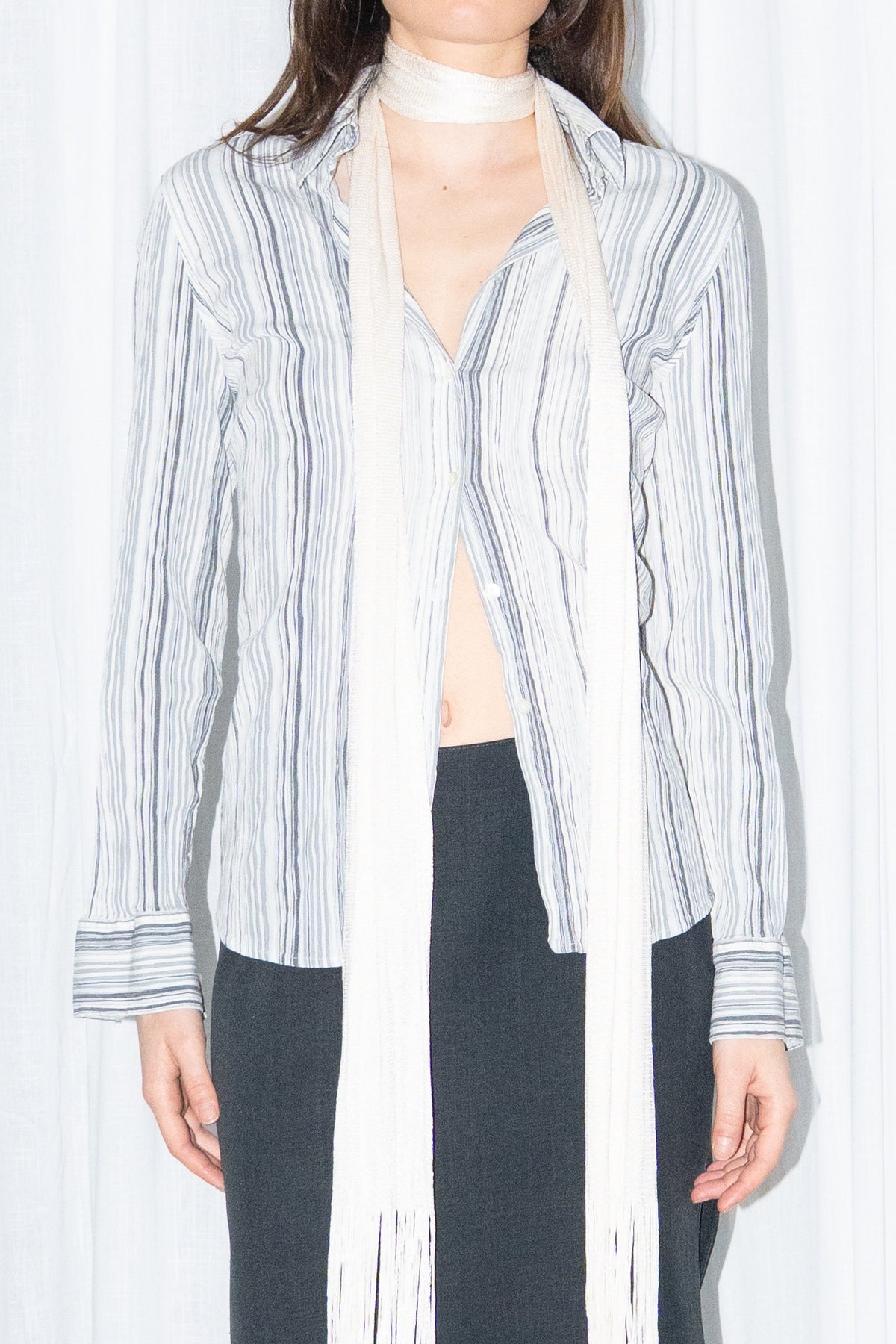 Close-up of blue grey striped button-up shirt with a cream fringed scarf – MINIFALDA