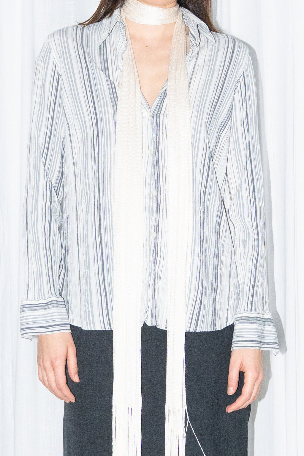 Close-up of blue grey striped button-up shirt with a cream fringed scarf – MINIFALDA