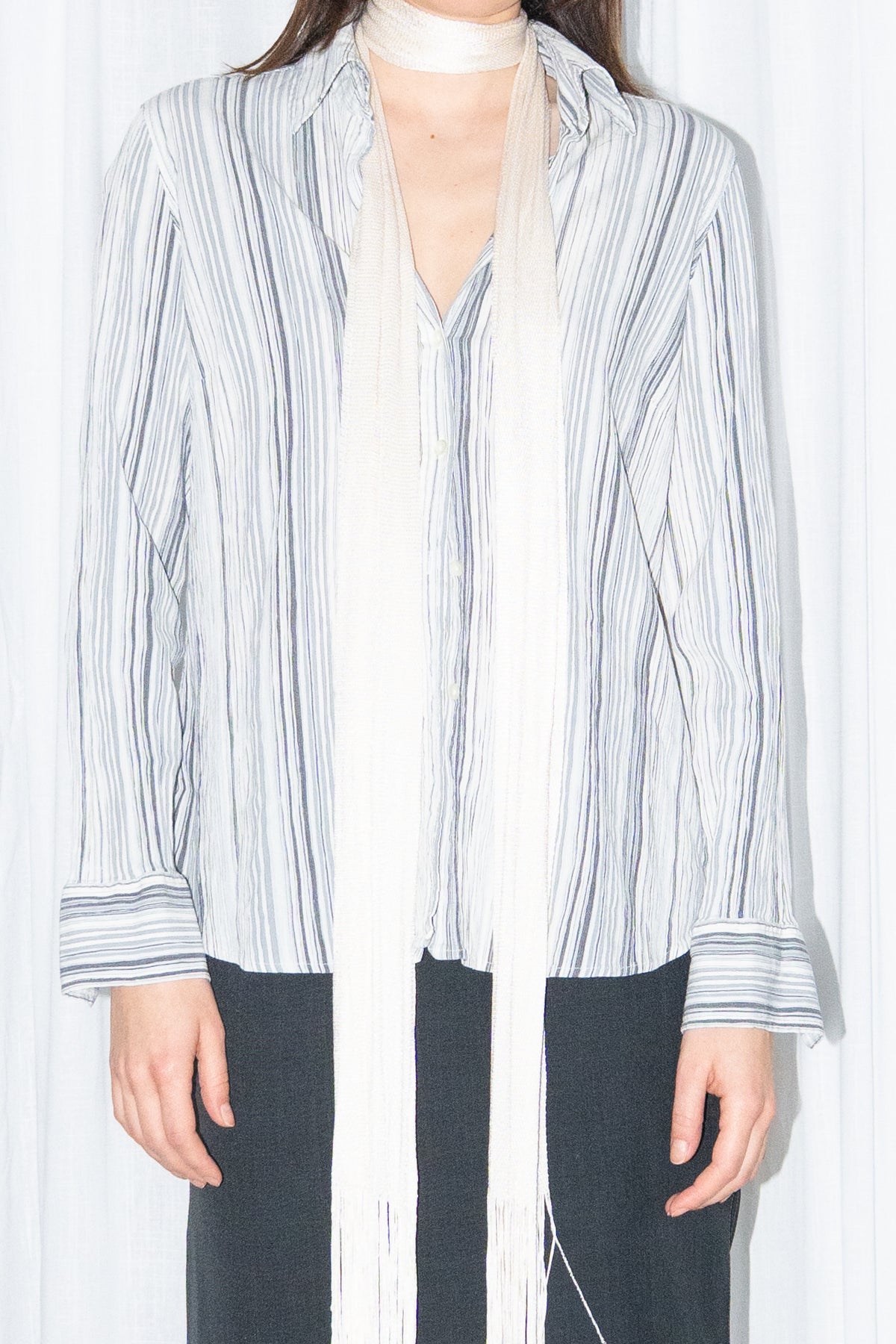 Close-up of blue grey striped button-up shirt with a cream fringed scarf – MINIFALDA