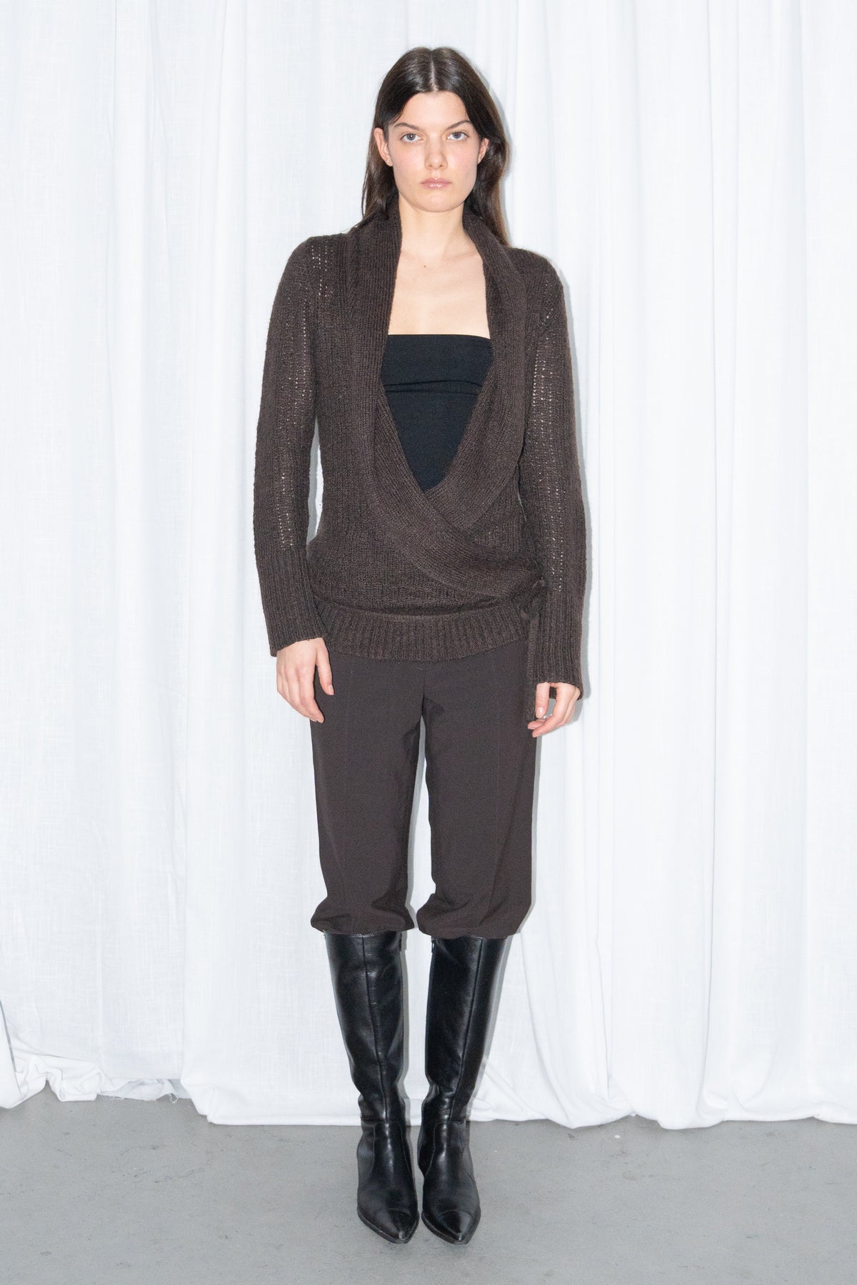 Model wearing brown wrap-front wool and mohair knit cardigan with a black tube top and brown trousers – MINIFALDA