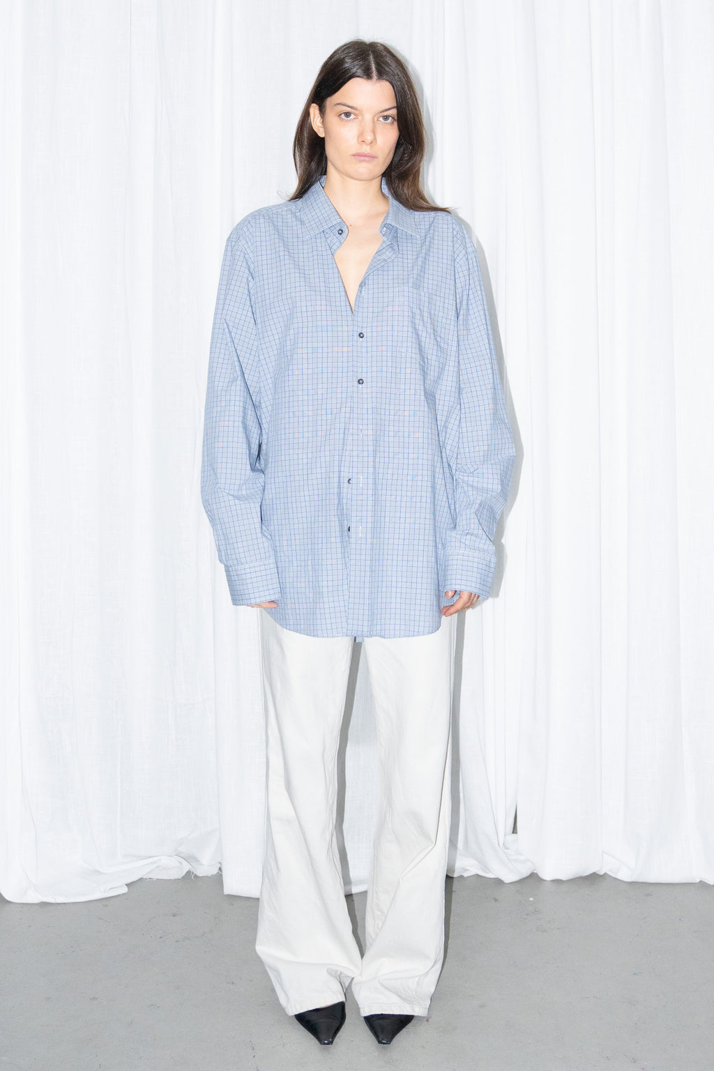 Front view of a light blue oversized button-up shirt with white wide-leg trousers