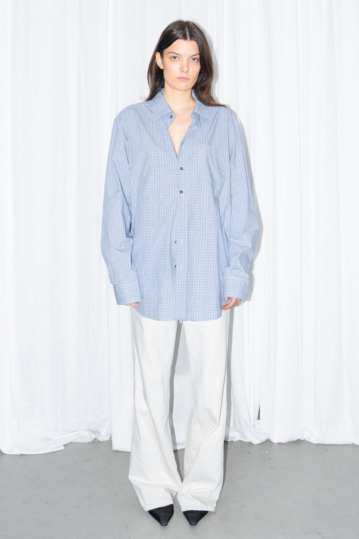 Front view of a light blue oversized button-up shirt with white wide-leg trousers
